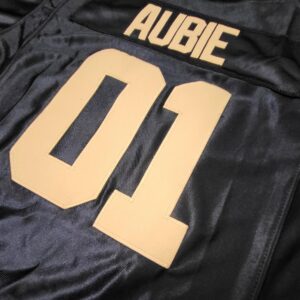 A black and gold jersey with the name aubie on it.